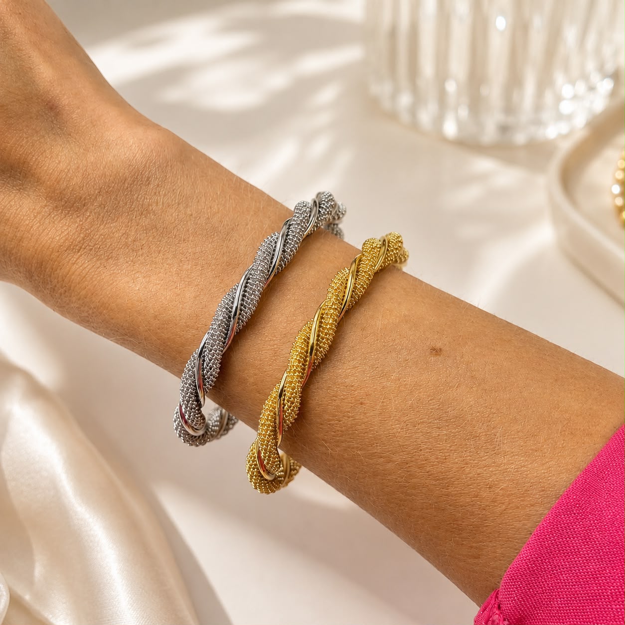 Elegant 18K Gold Filled twisted mesh cuff bracelet featuring a woven textured design with polished twisted accents. Lightweight, adjustable and perfect for everyday wear.