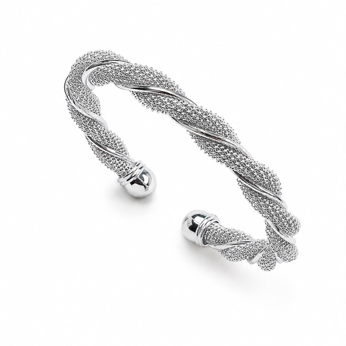 A sterling silver mesh cuff bracelet features a twisted design ending in polished ball terminals against a white background.