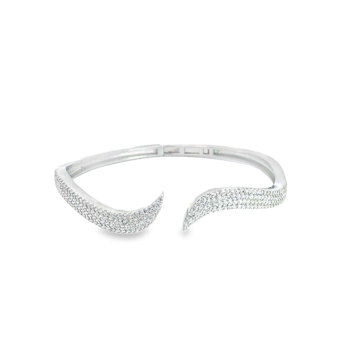 A silver bypass cuff bracelet sparkles with pavé-set diamonds along its wavy ends against a white background.