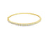 A delicate gold bangle bracelet sparkles with a continuous row of pave-set diamonds against a clean white background.
