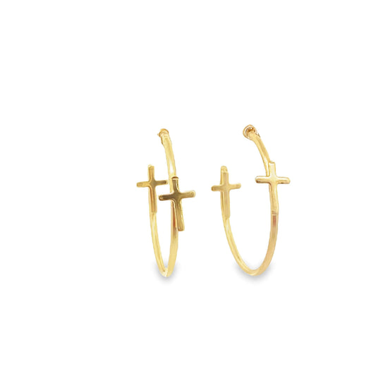 A pair of gold hoop earrings featuring dangling cross charms display a delicate religious design against a plain white background.