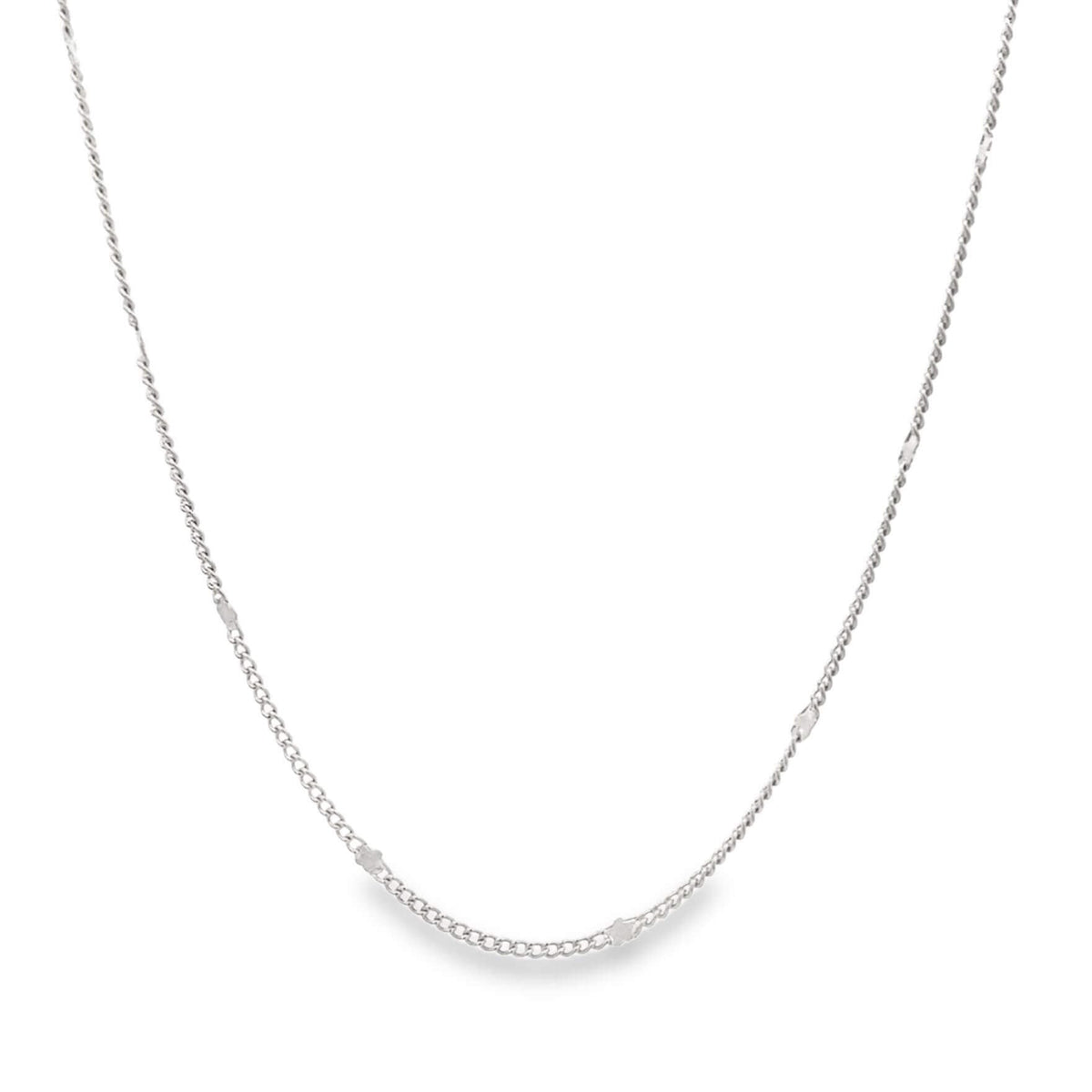A delicate silver chain necklace drapes against a clean white background.