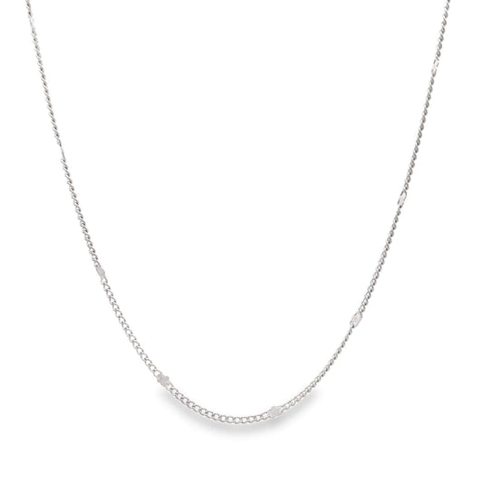 A delicate silver chain necklace drapes against a clean white background.