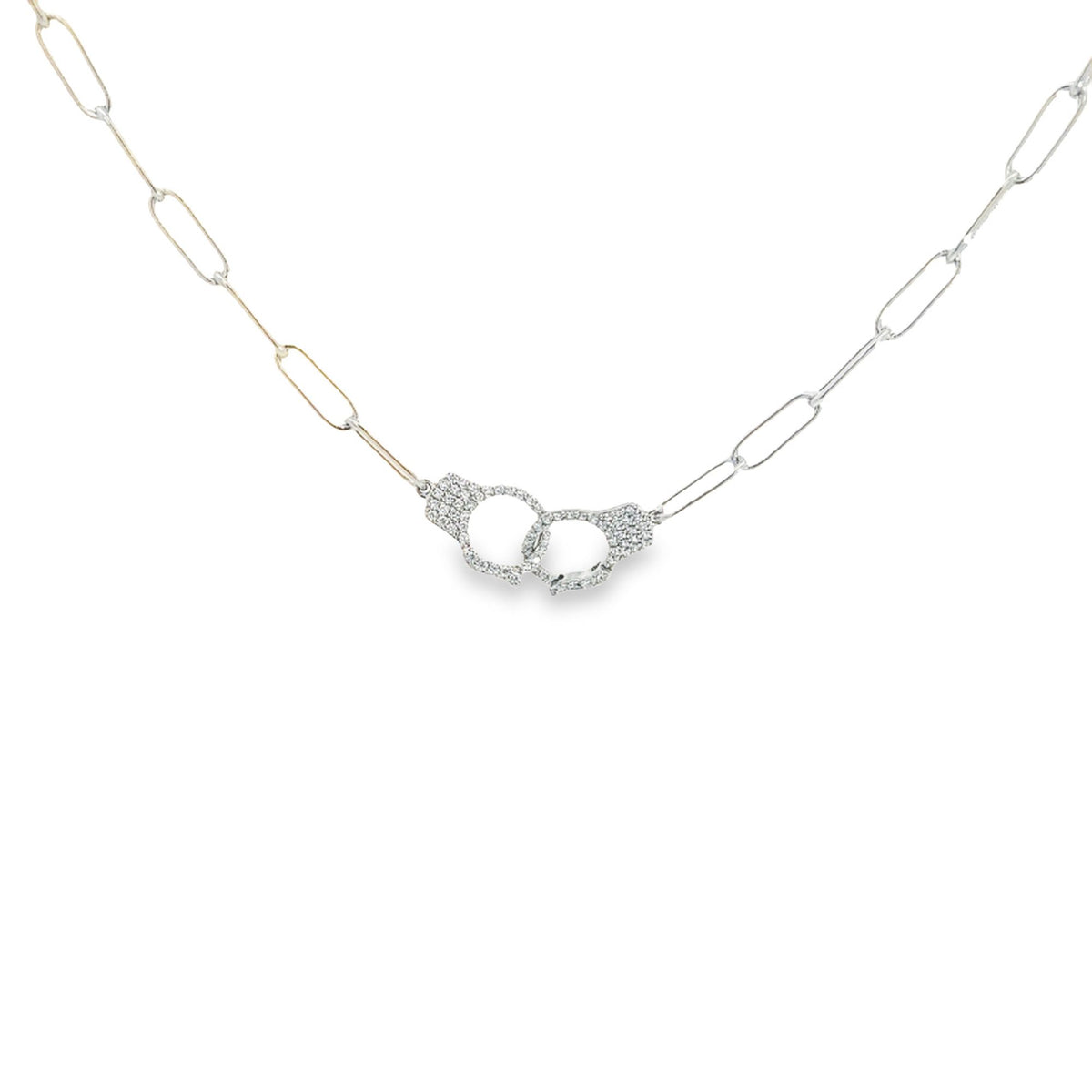 A two-tone paperclip chain necklace features a sparkling diamond-paved handcuff pendant.