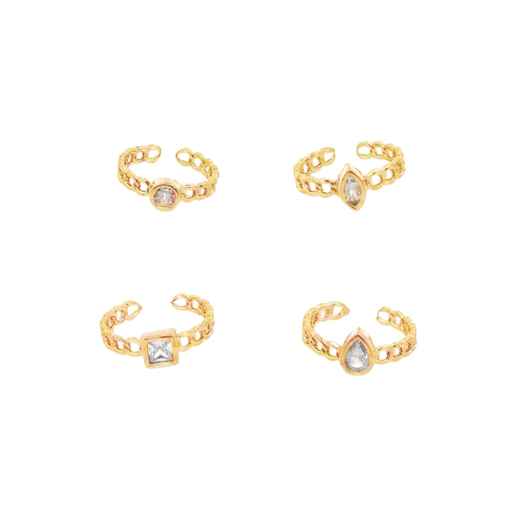 Four gold chain rings feature distinct crystal settings in round, marquise, square, and teardrop shapes.