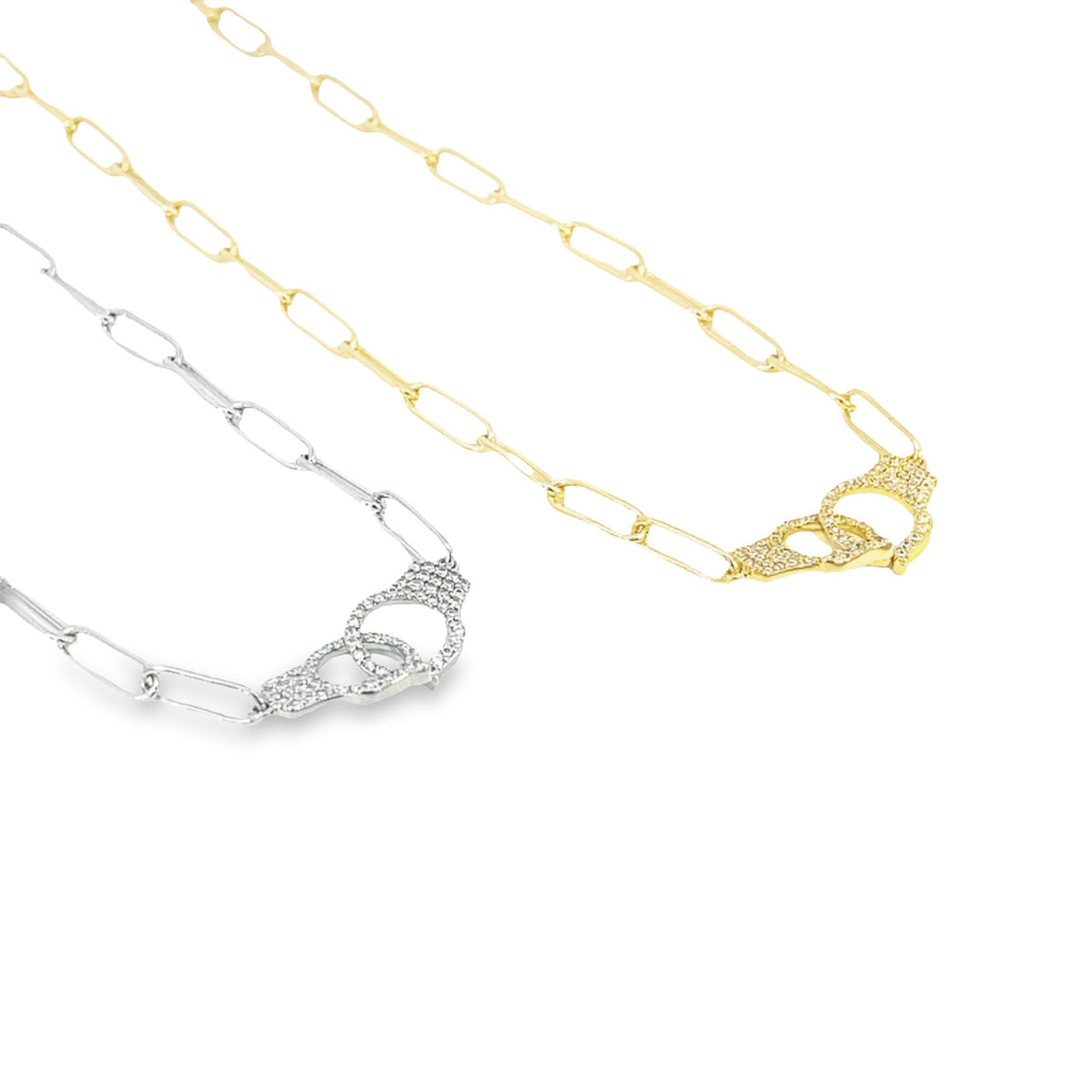 Two gold and silver paperclip chain necklaces feature interlocking handcuff pendants embellished with pavé diamonds against a clean white background.