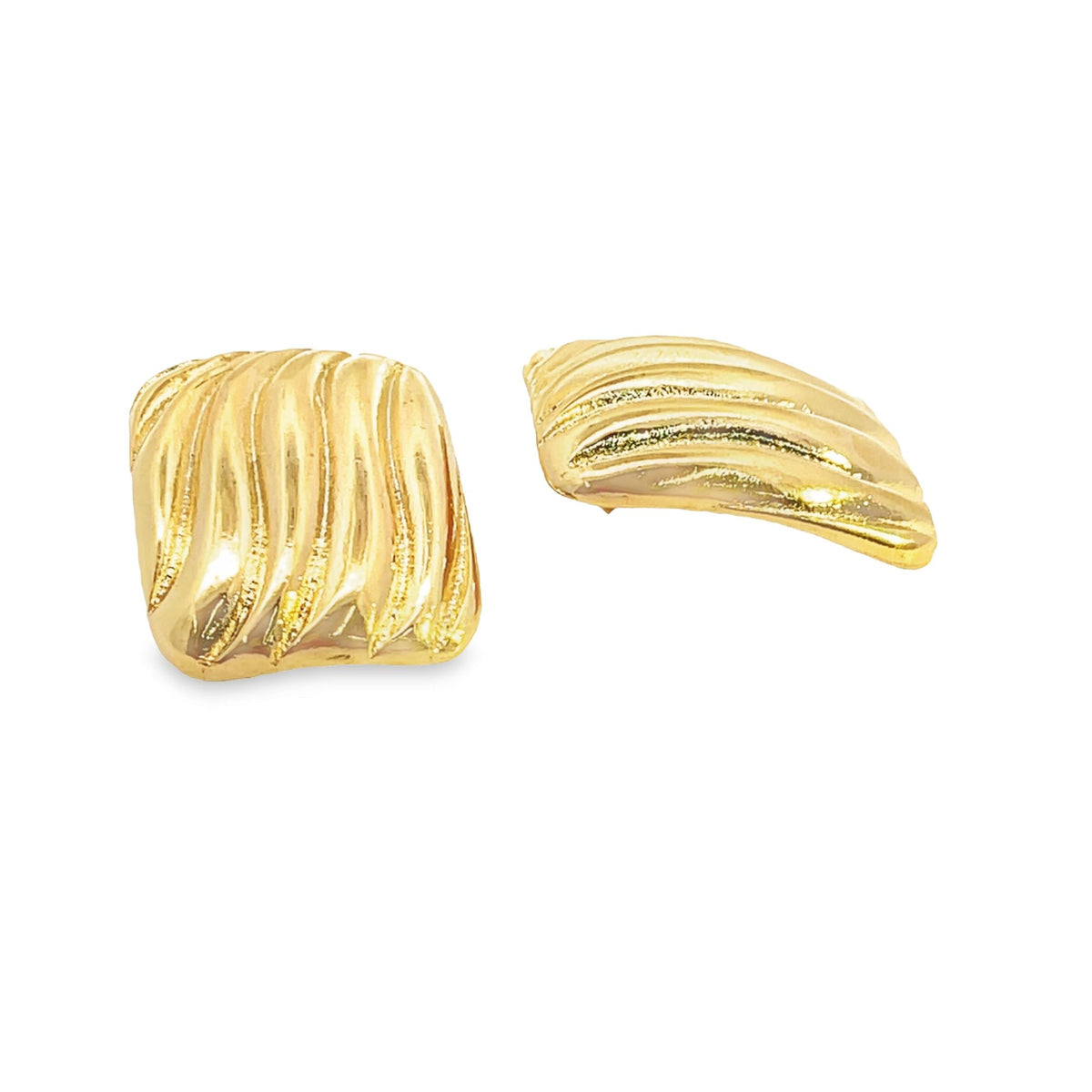 A pair of textured gold earrings featuring a rippled, shell-like design rests against a clean white background.