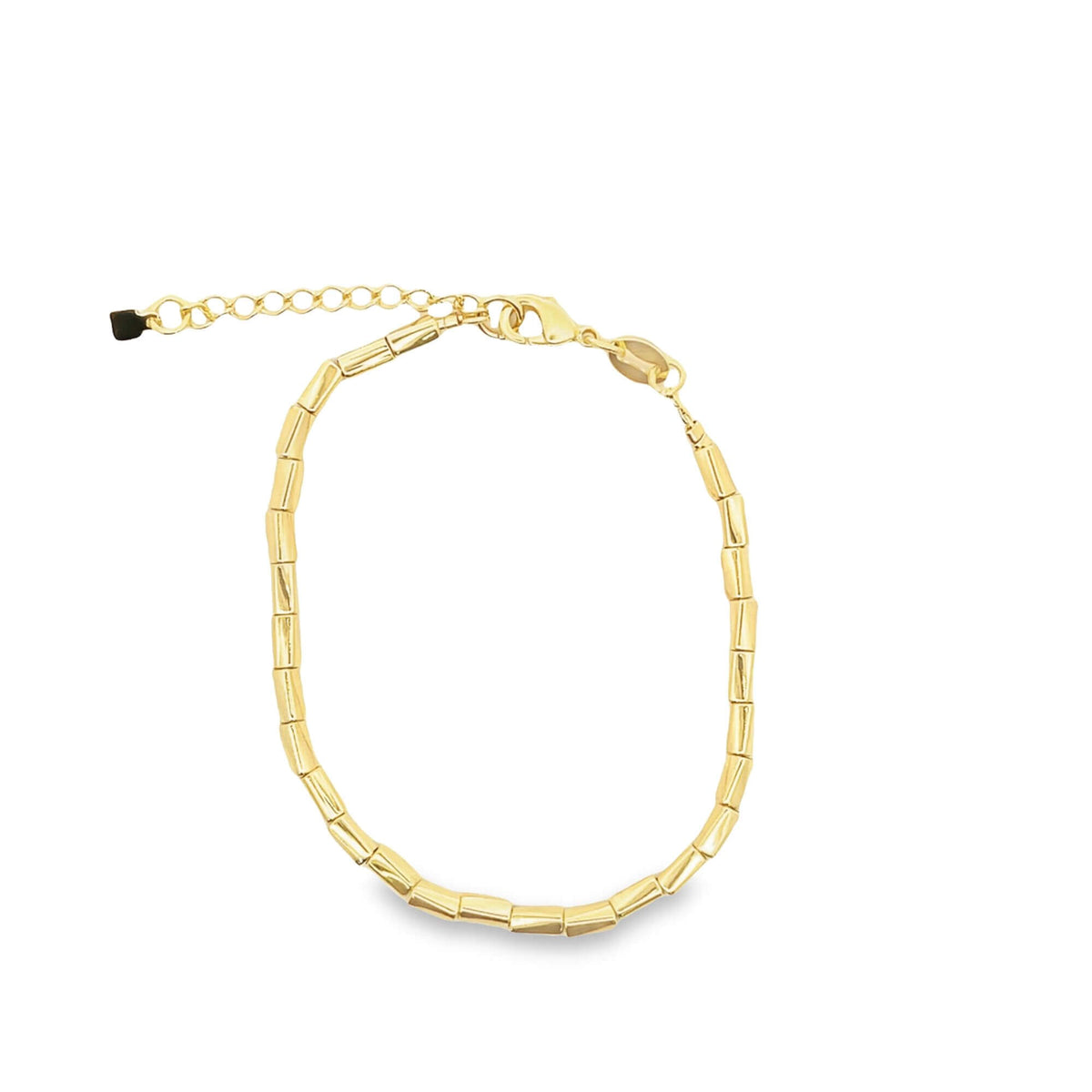 A gold link bracelet featuring cylindrical segments sits against a plain white background.