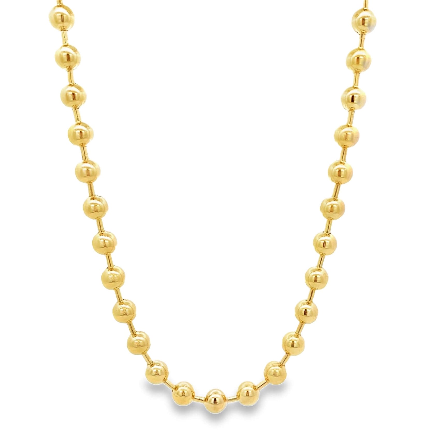 A shiny gold ball chain necklace drapes against a clean white background, showcasing its polished bead links.