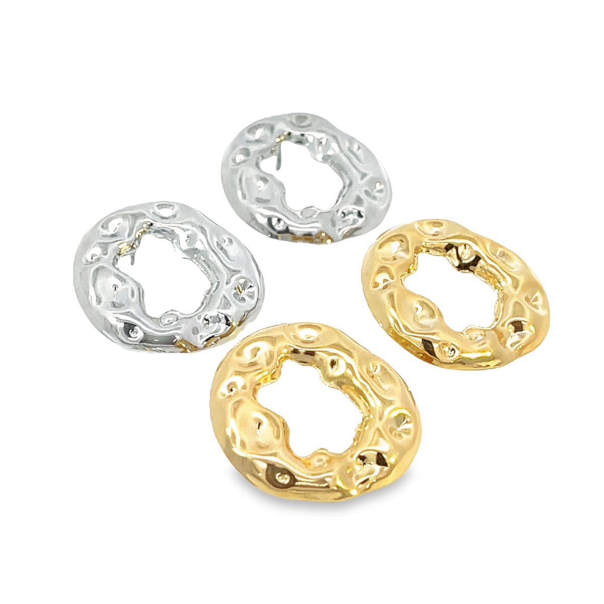 Four chunky, organic-shaped metal earrings in polished gold and silver finishes rest against a clean white background.