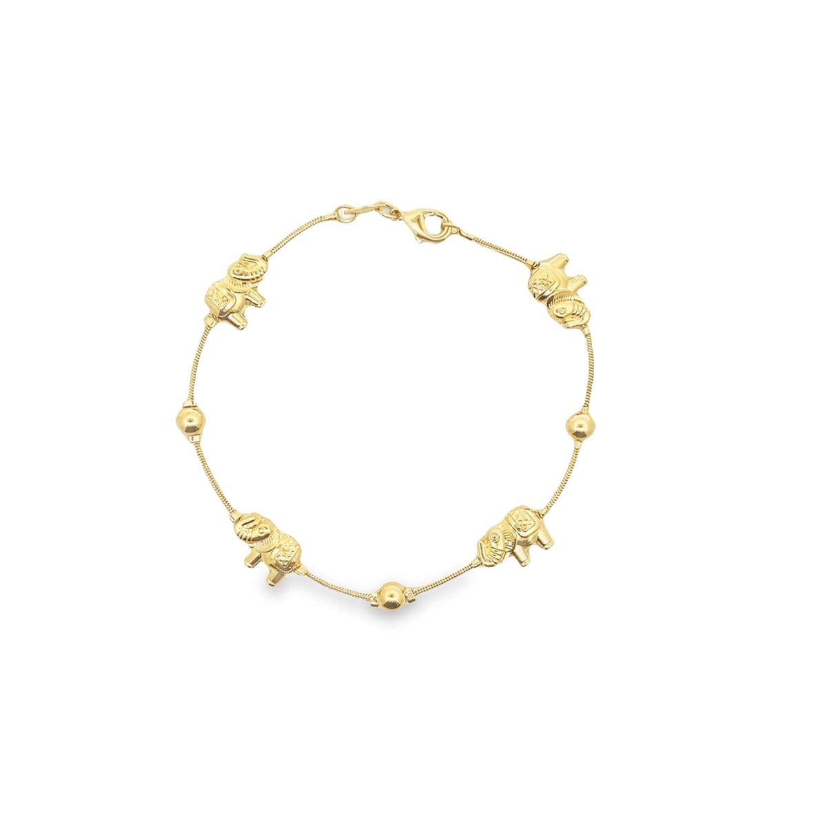 A delicate gold charm bracelet displays alternating elephant charms and golden beads on a fine chain against a white background.