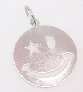 A shiny silver smiley face pendant features a star-shaped eye and a wide, cheerful grin.