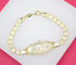 A gold link bracelet featuring an engraved plaque that spells out the word "love" rests on a white display stand against a vibrant pink background.