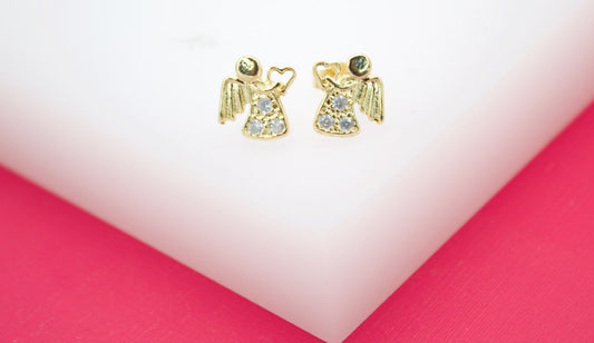 A pair of gold angel stud earrings featuring sparkling cubic zirconia stones rest on a white display stand.
