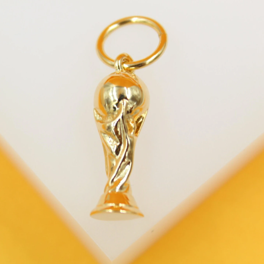 A shiny gold World Cup trophy pendant hangs from a matching jump ring against a clean white and yellow background.