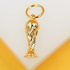 A shiny gold World Cup trophy pendant hangs from a matching jump ring against a clean white and yellow background.