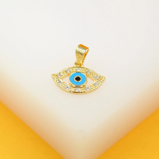 A gold evil eye pendant sparkles with cubic zirconia stones and features a bright blue and black center against a white display surface.