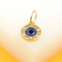 A gold evil eye pendant features a blue enamel center surrounded by sparkling cubic zirconia stones.