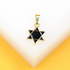 A gold Star of David pendant featuring black enamel rests on a white and yellow display surface.