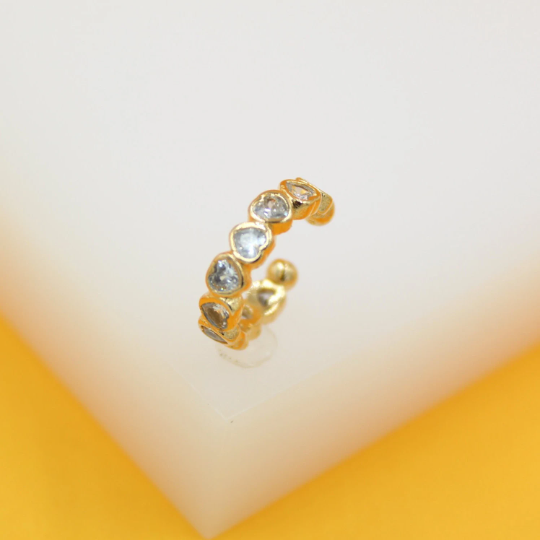 A gold-plated ear cuff features a row of sparkling heart-shaped zirconia stones.