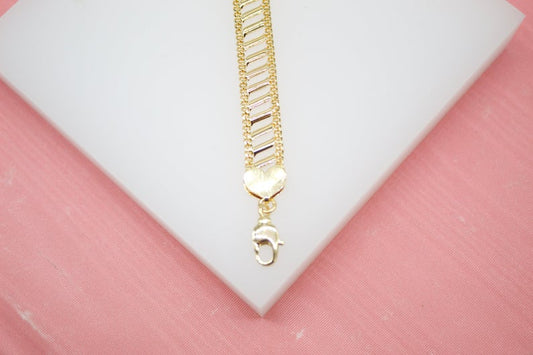 A textured gold bracelet featuring a heart-shaped charm and clasp rests on a white display surface.