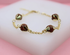 A delicate gold chain bracelet features sparkling brown sandstone bead charms cradled in decorative golden settings.