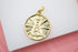 A polished gold pendant features an embossed image of Our Lady of Aparecida surrounded by radiating sunburst lines.
