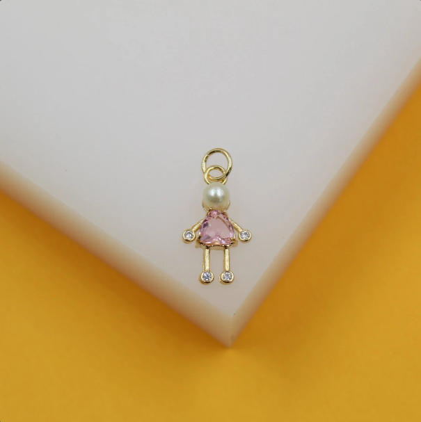 A delicate gold girl charm features a pearl head, a pink crystal dress, and sparkling cubic zirconia accents on its hands and feet.