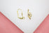 Two shiny gold leverback earring findings lie side by side on a neutral surface.