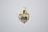 A gold and silver heart-shaped pendant featuring a textured elephant design rests against a plain white background.