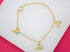 A delicate gold-plated chain bracelet features playful ABC alphabet letter charms enameled in pastel pink, yellow, and blue.