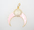 A gold crescent moon charm features pink enamel and a circular white accent bordered with sparkling crystals.
