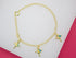A delicate gold charm bracelet displays three colorful umbrella charms on a light background.