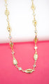 A gold necklace features alternating cowrie shells and sparkling cubic zirconia stones.