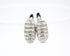 A pair of silver hoop earrings studded with shimmering cubic zirconia stones rest against a clean white background.