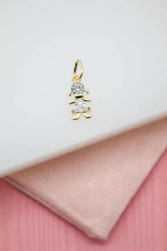 A delicate gold pendant shaped like a little girl features sparkling cubic zirconia stones for her head and dress.