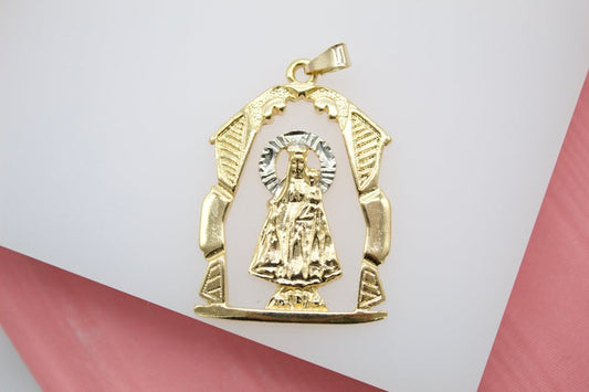 A gold and white gold pendant depicts Our Lady of Altagracia framed inside an ornate archway.
