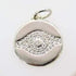 A gleaming silver evil eye pendant sparkles with embedded cubic zirconia stones against a neutral background.