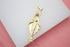 A gold Virgin Mary pendant features a diamond-encrusted halo against a white surface.