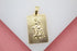 A rectangular gold pendant features a textured engraving of Saint Christopher carrying a child against a sunburst background.