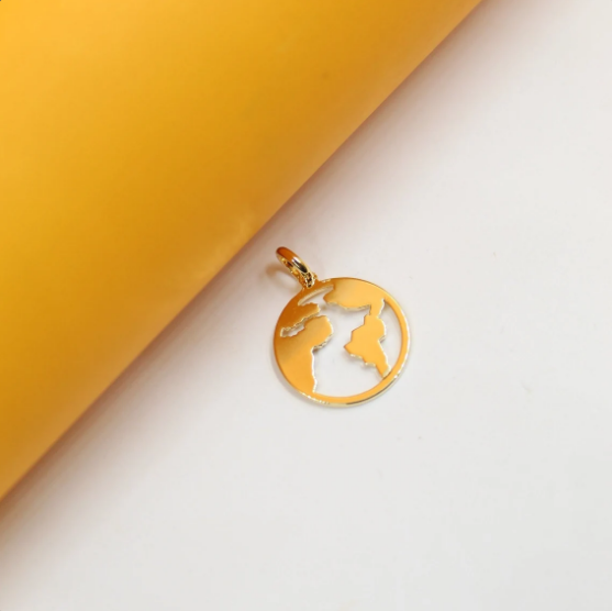 A shiny gold globe pendant rests on a clean white and yellow background.