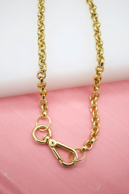 A thick gold rolo chain necklace features a sturdy lobster clasp fastening.
