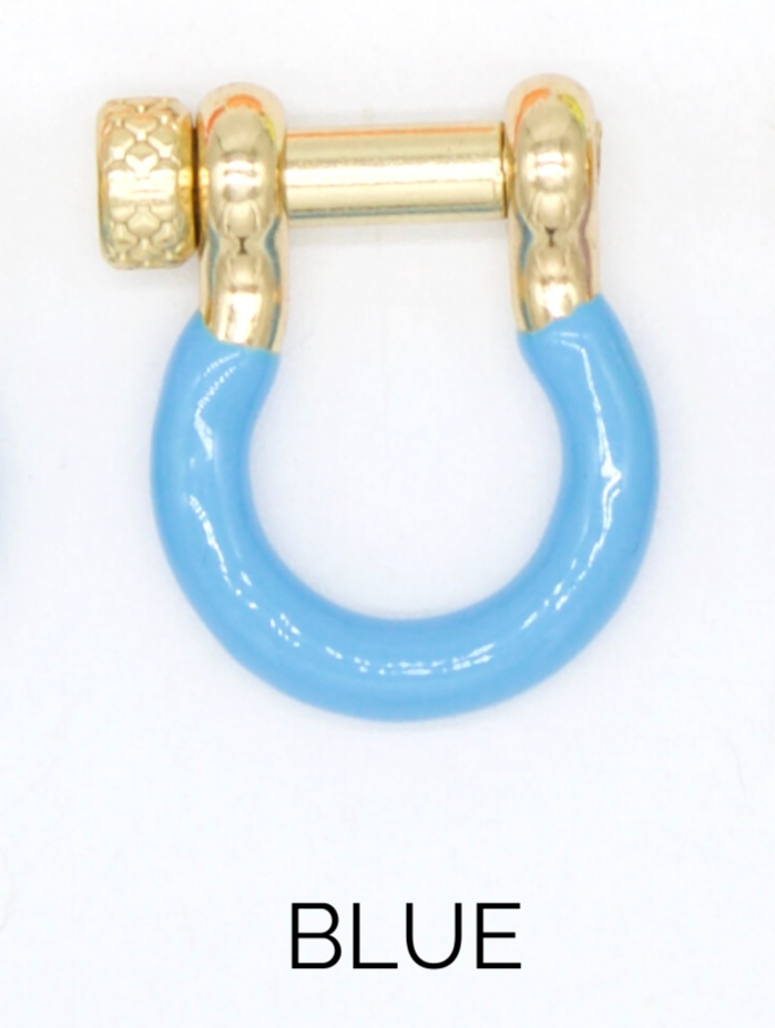 A horseshoe-shaped charm earring features a glossy blue enamel lower half and a polished gold-plated top with a textured screw pin.