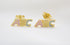 A pair of gold ABC alphabet stud earrings features colorful enamel letters on a white background.
