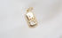 A gold paw print pendant necklace sparkles against a soft, textured white fabric background.