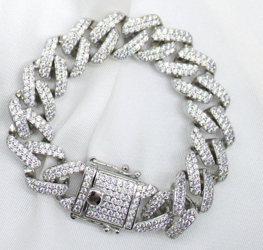 A sparkling diamond cuban link bracelet rests on a white background.