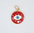 A gold-rimmed red enamel evil eye pendant features a central blue and white eye design against a glossy background.