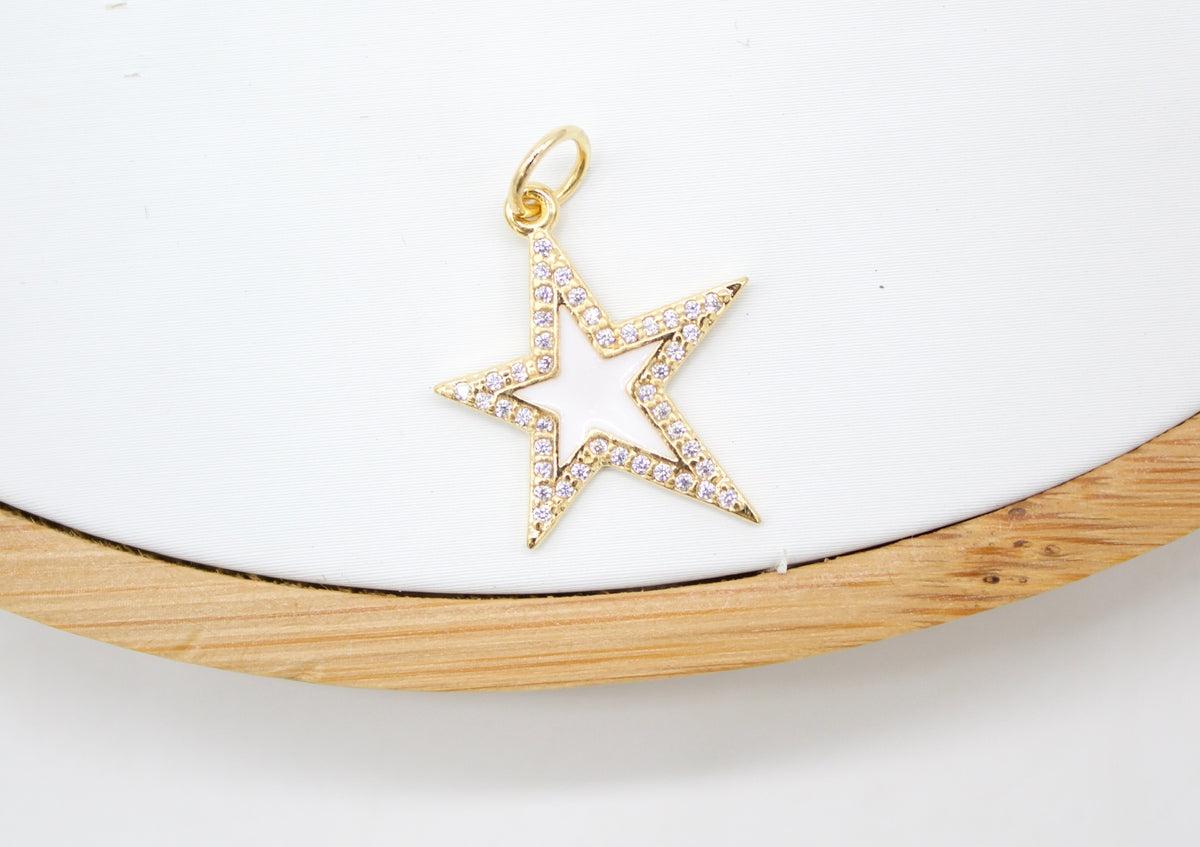 A gold star pendant with pave diamonds rests on a white display surface.