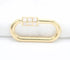 A gold oval charm connector features a white enamel grid clasp on a white background.