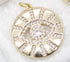 A gold evil eye pendant sparkles with pave-set cubic zirconia crystals arranged in a protective sunburst design.